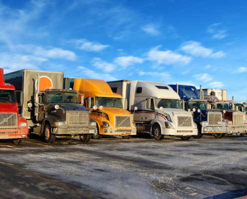 Side view of the front of multiple semitrucks